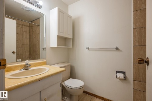 Bathroom vanity with an integrated sink and chrome faucet - 20 11115 27 Avenue, Edmonton, AB 