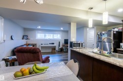 Kitchen island with a light-toned countertop and dark wood-finish cabinetry - 