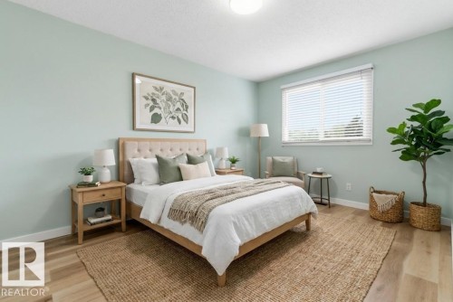 Bedroom featuring wood-finish flooring, a contemporary ceiling light fixture, and a large window with horizontal blinds - 13279 47 Street, Edmonton, AB - Indoor Photo Showing Bedroom
