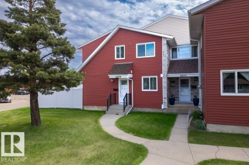 Red siding exterior with white trim windows and a prominent front entrance - 13279 47 Street, Edmonton, AB - Outdoor