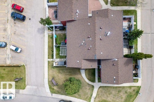 Aerial view of a residential complex featuring brown shingle roofing and individual fenced backyard spaces - 13279 47 Street, Edmonton, AB - Outdoor