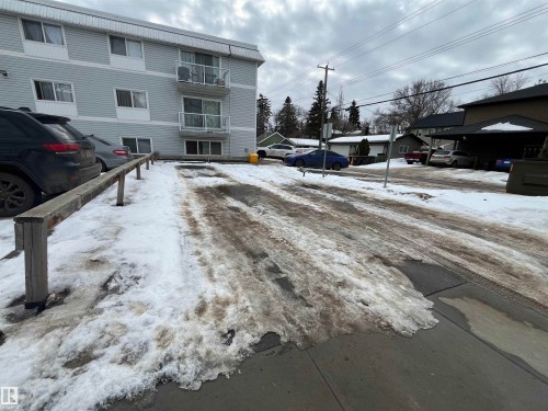 Multi-story residential building with light-colored siding - 306 11340 124, Edmonton, AB 