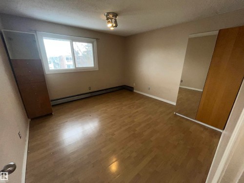 Room with wood-finish flooring, a double window, and baseboard heating - 306 11340 124, Edmonton, AB 