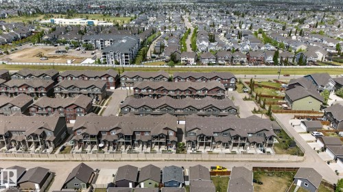 Aerial perspective showcasing a residential community with varied housing styles - 62 3305 Orchards Link, Edmonton, AB 