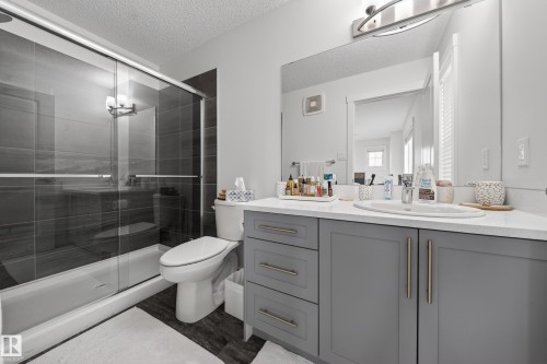 Bathroom featuring a gray vanity with an undermount sink and a white countertop - 5 903 Crystallina Nera Way, Edmonton, AB 