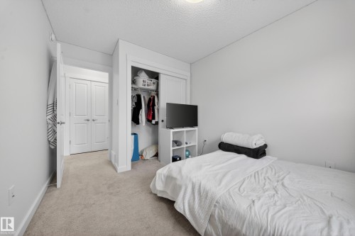 Neutral-toned carpeting enhances the room's bright white walls - 5 903 Crystallina Nera Way, Edmonton, AB 