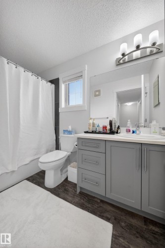 Bathroom featuring a single-sink vanity with gray cabinetry, a white countertop, and contemporary chrome hardware - 5 903 Crystallina Nera Way, Edmonton, AB 