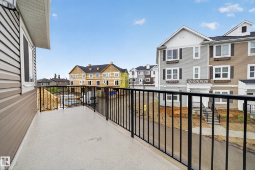 Exterior balcony featuring a concrete surface and black metal railings - 5 903 Crystallina Nera Way, Edmonton, AB 