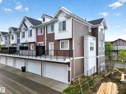 Multi-level townhome featuring varied siding textures and colors - 5 903 Crystallina Nera Way, Edmonton, AB 