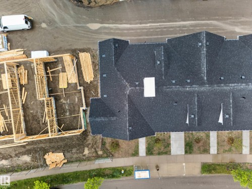 Newly constructed townhome with a dark shingle roof and multiple skylights - 5 903 Crystallina Nera Way, Edmonton, AB 