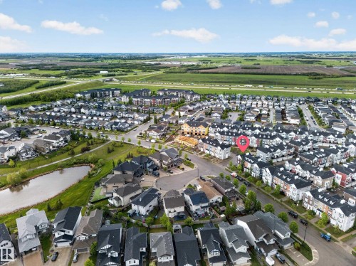 Aerial view of a residential community featuring varied housing styles including detached homes and townhomes - 5 903 Crystallina Nera Way, Edmonton, AB 