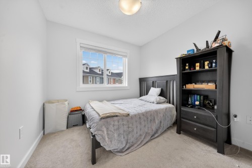 Bright room featuring light gray walls and window with white trim - 5 903 Crystallina Nera Way, Edmonton, AB 