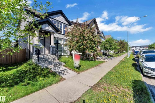 Modern home with light gray siding and contrasting dark trim - 621 Mcdonough Link Link, Edmonton, AB 