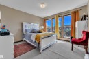 Bedroom featuring multiple large windows, neutral wall tones, and a ceiling-mounted light fixture - 621 Mcdonough Link Link, Edmonton, AB 