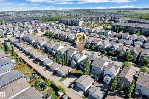 Aerial perspective showcasing a residential neighborhood with detached homes and multi-story apartment buildings - 621 Mcdonough Link Link, Edmonton, AB 