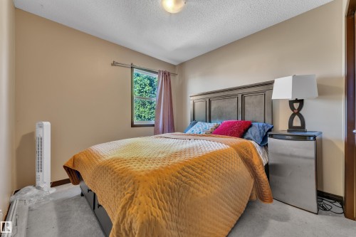 Bedroom featuring a window with natural light, neutral wall paint, and carpet flooring - 621 Mcdonough Link Link, Edmonton, AB 
