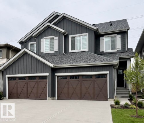 Contemporary two-story residence featuring dark gray siding and a gray shingle roof - 19704 29 Avenue, Edmonton, AB 