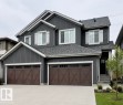 Contemporary two-story residence featuring dark gray siding and a gray shingle roof - 19704 29 Avenue, Edmonton, AB 