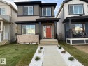 Modern two-story residence with a multi-tone facade featuring horizontal siding and stone accents - 317 Juniper Cove, Leduc, AB 
