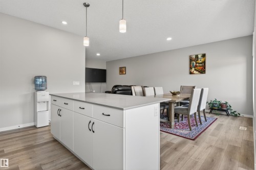 Kitchen island featuring white cabinetry, dark hardware, and a light-toned countertop - 22638 99A Avenue, Edmonton, AB 