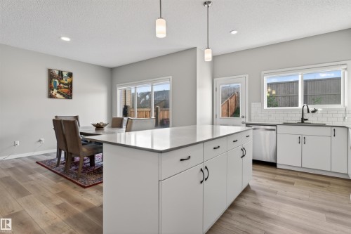 Open-concept kitchen and dining area with wood-finish flooring - 22638 99A Avenue, Edmonton, AB 