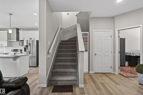 Staircase featuring carpeted treads and a white handrail - 22638 99A Avenue, Edmonton, AB 