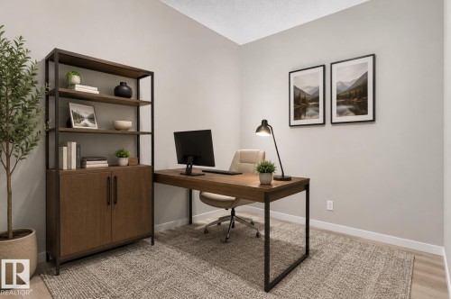 Dedicated workspace featuring a wood-finish desk with a metal frame, light-toned walls, and a built-in shelving unit with lower cabinetry - 22638 99A Avenue, Edmonton, AB 
