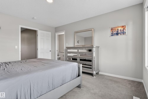 Bedroom featuring light gray wall paint, gray carpeting, and a recessed ceiling light - 22638 99A Avenue, Edmonton, AB 