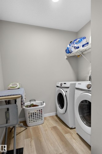 Dedicated laundry area featuring wood-finish flooring and light gray walls - 22638 99A Avenue, Edmonton, AB 