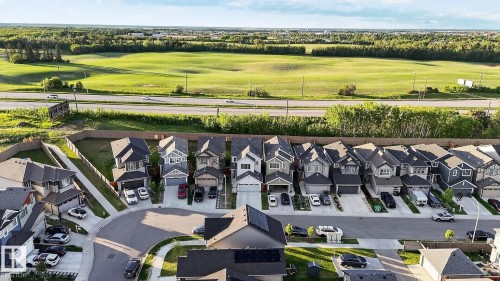 Residential development featuring a variety of architectural styles, paved roadways, and surrounding green space with distant tree lines - 22638 99A Avenue, Edmonton, AB 