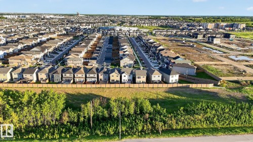 Expansive residential development featuring numerous newly constructed homes, paved streets, and a mix of completed and developing lots - 22638 99A Avenue, Edmonton, AB 