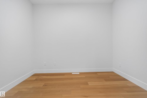 Room featuring light wood-finish flooring, white baseboards, and neutral wall tones - 15 Redbud Way, St. Albert, AB - Indoor Photo Showing Other Room