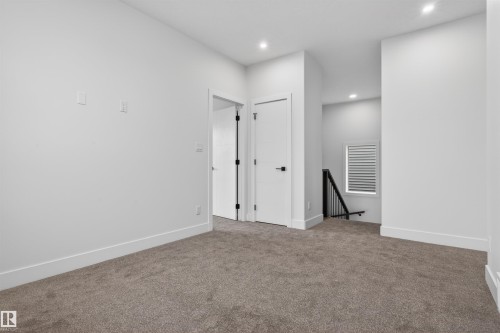 Carpeted interior space featuring white walls and recessed lighting - 15 Redbud Way, St. Albert, AB - Indoor Photo Showing Other Room
