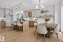Expansive open-concept kitchen and dining area featuring light wood-finish flooring - 15 Redbud Way, St. Albert, AB  - Indoor Photo Showing Dining Room 