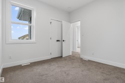 Room featuring a single window, white trim, light gray carpeting, and white walls - 