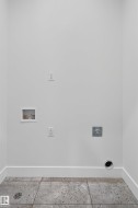 Dedicated utility space featuring a laundry hookup, dryer vent, and electrical outlets - 