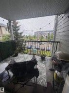 Covered balcony featuring a black metal railing and exterior siding - 