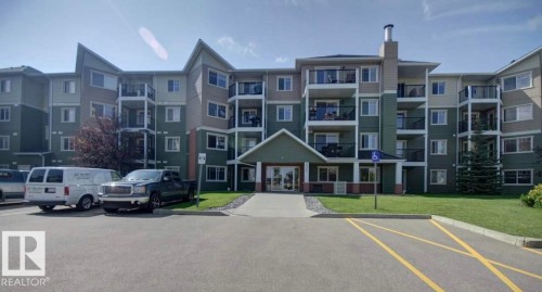 Multi-story residential building featuring a gabled entry with a covered porch - 317 6921 199 Street, Edmonton, AB 