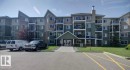 Multi-story residential building featuring a gabled entry with a covered porch - 317 6921 199 Street, Edmonton, AB 