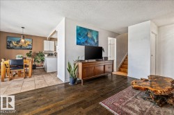 Living area featuring dark wood-finish flooring - 