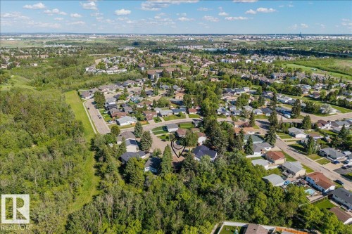 Aerial perspective showcasing a residential area bordered by expansive green spaces - 135 Homestead Crescent Nw, Edmonton, AB 