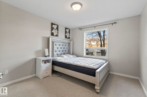 Bedroom featuring light gray wall paint, a single window with white trim, and a ceiling-mounted light fixture - 2106 9357 Simpson Dr Nw, Edmonton, AB - Indoor Photo Showing Bedroom