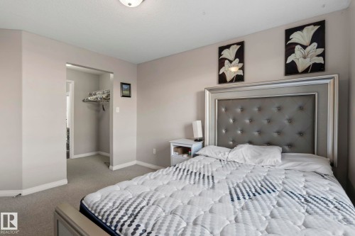 Carpeted room with light gray walls and a recessed doorway - 2106 9357 Simpson Dr Nw, Edmonton, AB - Indoor Photo Showing Bedroom