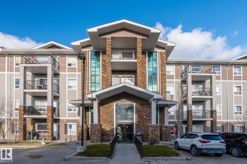 Multi-story building featuring a prominent stone facade entrance with a covered walkway - 2106 9357 Simpson Dr Nw, Edmonton, AB - Outdoor With Facade
