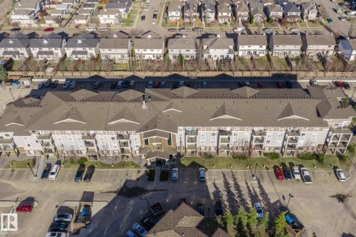 Multi-story residential building featuring balconies and a prominent central entrance - 2106 9357 Simpson Dr Nw, Edmonton, AB - Outdoor With View