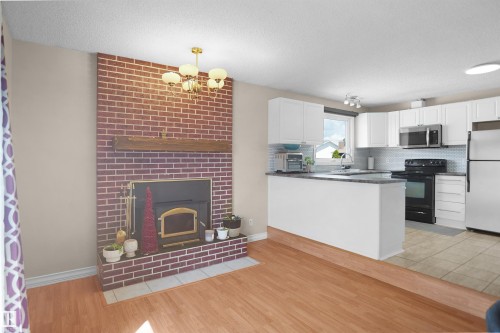 Living area with brick-clad fireplace and wood-finish flooring - 13524 26 Street, Edmonton, AB 