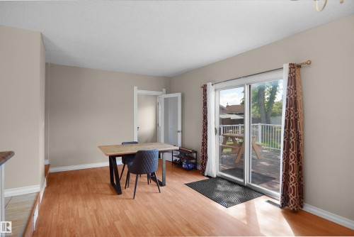Wood-finish flooring throughout, featuring neutral wall paint and white trim - 13524 26 Street, Edmonton, AB 