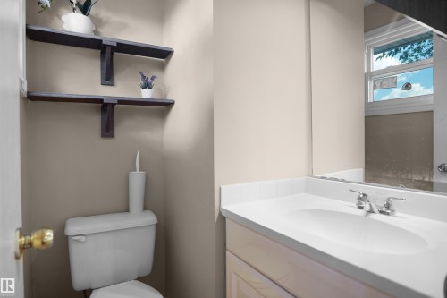 Bathroom vanity featuring a built-in sink and chrome faucet - 13524 26 Street, Edmonton, AB 