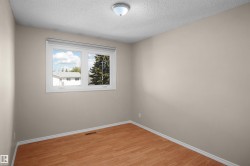 Bright room featuring wood-finish flooring and neutral wall tones - 