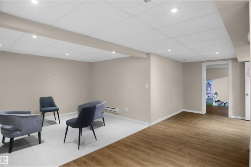 Spacious finished basement featuring recessed lighting, a drop ceiling, and neutral-toned walls - 13524 26 Street, Edmonton, AB 